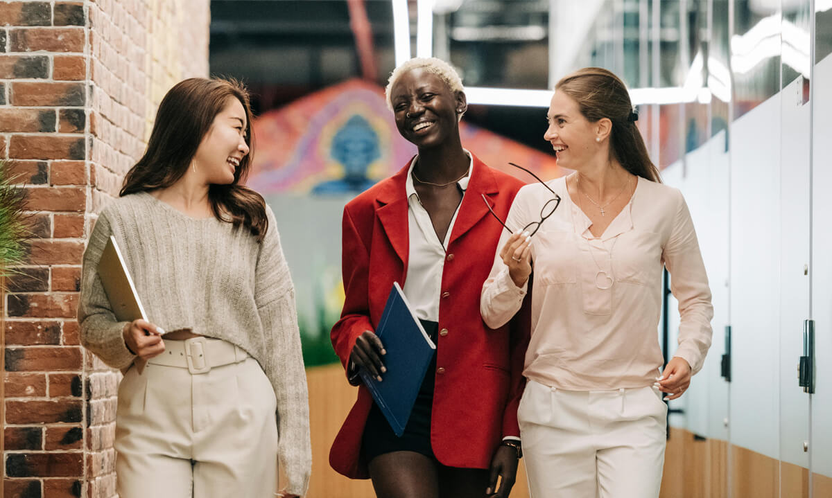 business women employees smiling walking at the office